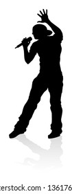 A singer pop, country music, rock star or hiphop rapper artist vocalist singing in silhouette