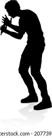 A singer pop, country music, rock star or hiphop rapper artist vocalist singing in silhouette