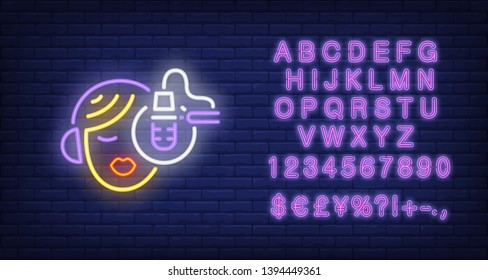 Singer in studio neon icon. Singing character in headphones at mic on brick wall background. Music industry concept. Vector illustration can be used for neon signs, billboards, show business