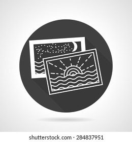Single black round flat design vector icon with white contour two cards or photo with sunset and night seascape on gray background.