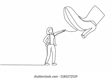 Single continuous line drawing active businesswoman facing against giant shoes stomping. Office worker pointing against giant foot step. Minimalism metaphor. One line draw design vector illustration
