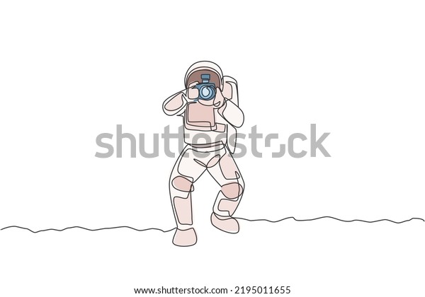 Single continuous line drawing astronaut doing
photography with dslr camera in moon surface. Having fun in leisure
time on outer space concept. Trendy one line draw design vector
illustration graphic