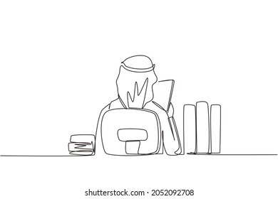 Single continuous line drawing back view of young Arabic man sitting at desk and reading book, student studying hard, preparing before exam with pile of books. One line draw design vector illustration