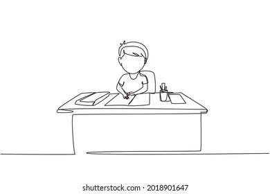 Single continuous line drawing boy studying on table with stationery such as books, pencils, pens. Kid makes homework from school. Intelligent student. One line draw graphic design vector illustration