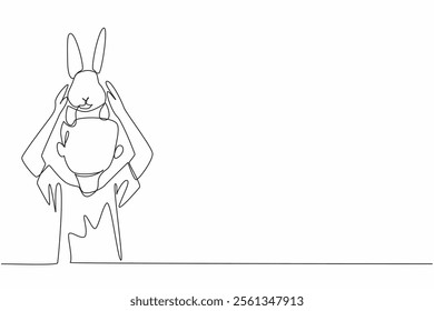 Single continuous line drawing the boy puts rabbit on his head. Inviting a cute bunny to joke. Nurtured from childhood. Like family. National Kids and Pets Day. One line design vector illustration