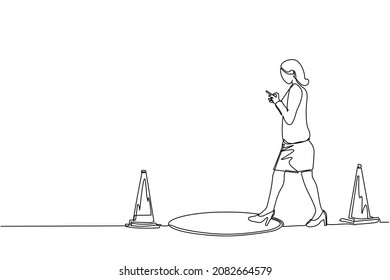 Single continuous line drawing businesswoman character going on street watching by smart phone, did not see open manhole. Woman walks to business trap. One line draw graphic design vector illustration
