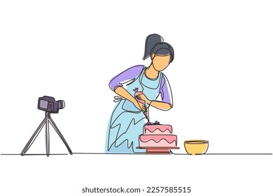 Dibujo de una sola línea contínua que horneaba y decoraba pasteles en la cocina. Bloguera mujer grabando video en cámara, usando trípode, publicándolo en medios sociales. Ilustración vectorial de diseño de líneas de una línea