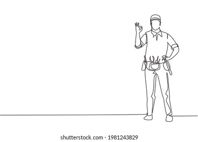 Single continuous line drawing handyman stands with gesture okay and tools such as pliers, screwdriver, hammer that placed on his work shirt. Dynamic one line draw graphic design vector illustration