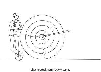 Single continuous line drawing happy businessman or manager is standing near target. Arrow hit target exactly. Making goals, successful business strategy. Dynamic one line draw graphic design vector