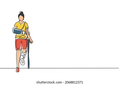 Single continuous line drawing injured woman having head bandage, broken ankle, wrist cast walking with crutch, and medical plaster on leg and arm. One line draw graphic design vector illustration