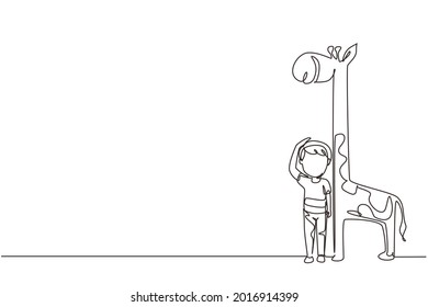 Single continuous line drawing little boy measuring his height with giraffe height chart on wall. Kid measures growth. Child measuring height. Dynamic one line draw graphic design vector illustration