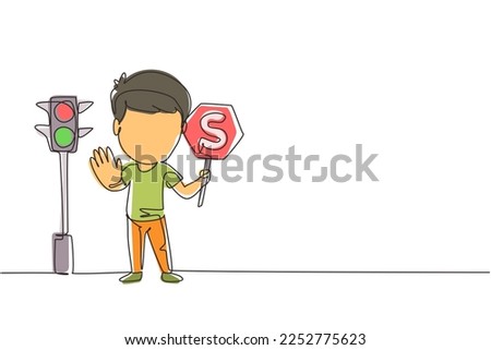 Single continuous line drawing little boy holding stop sign in arm standing near road, pedestrian rules for kids, traffic light in vector style. Child holding stop sign. Dynamic one line draw graphic