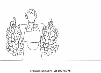 Single continuous line drawing male farmer holding two bunches of bananas with both hands. Abundant banana harvest. Healthy snack. Fruit. National Agriculture Day. One line design vector illustration