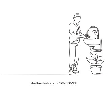 Single continuous line drawing a man washes his hands in the sink, there is a soap dispenser by the faucet and there is a pot of plants under the sink. One line draw graphic design vector illustration