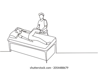 Single Continuous Line Drawing Man Lying On Massage Table Professional Masseur Therapist Doing Healing Treatment Massaging Patient Treating Knee Manual Physical Therapy. One Line Draw Design Vector