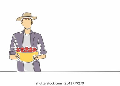 Uma única linha contínua desenhando um homem usando um chapéu carregando um recipiente cheio de tomates. Trazendo uma colheita satisfatória. Produtor de tomate. Vitamina Dia do Tomate Fresco. Ilustração de vetor de design de uma linha