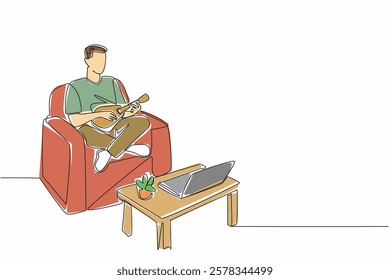 Single continuous line drawing man sit cross legged on sofa playing ukulele looking at laptop screen. Learn to play ukulele online. National Play Your Ukulele Day. One line design vector illustration