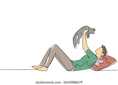Single continuous line drawing a man in casual clothes lying down lifting and hugging a cat. Adorable game with pet cat. Cheerful. International Hug Your Cat Day. One line design vector illustration