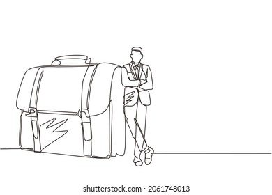 Single continuous line drawing modern confident male entrepreneur leaning on large briefcase. Happy businessman standing with elegance pose. Dynamic one line draw graphic design vector illustration