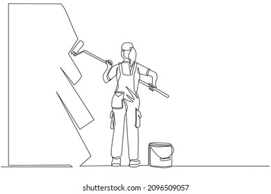 Single continuous line drawing painter decorator repairwoman people at work. Woman repair worker holding paintbrush roller, painting house apartment wall, home renovation. One line draw design vector