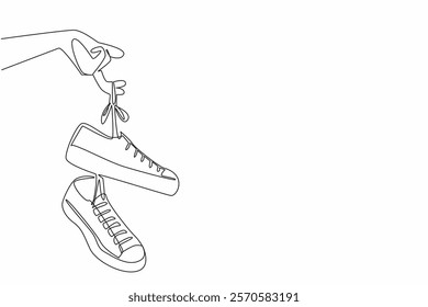 Single continuous line drawing a pair of sneakers with laces hanging from the fingers. Easy to carry. Attracts attention. National Two Different Colored Shoes Day. One line design vector illustration