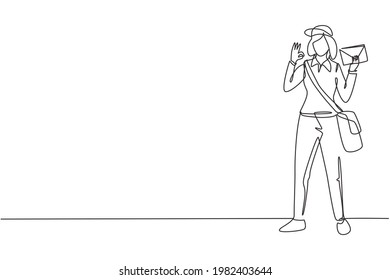 Single continuous line drawing postwoman standing with hat, sling bag, uniform, holding envelope, and gesture okay delivering mail to home address. One line draw graphic design vector illustration