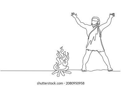 Single continuous line drawing prehistoric man standing around bonfire. Caveman stands and raised two of his hands around campfire. Warmth his body at night. One line draw design vector illustration