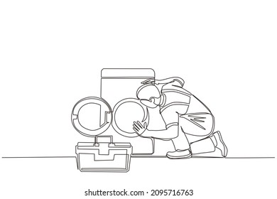 Single continuous line drawing professional repairman fixing washing machine at home. Plumbing specialist with toolbox fixing, repairing washer, washing machine. One line draw graphic design vector