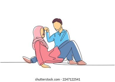 Single continuous line drawing romantic Arabian couple having picnic in park. Relaxing together sitting on the ground and men feeding grapes to women. One line draw graphic design vector illustration