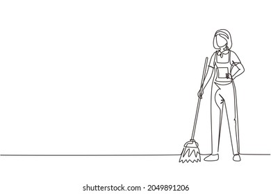 Single continuous line drawing smiling young woman janitor standing in uniform, sweeping the floor with broom, professional cleaning, home and office service. One line draw design vector illustration