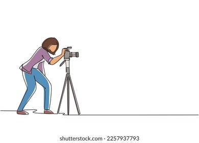 Single continuous line drawing super equipment female photographer, Woman holding, aiming cameras with standing tripod, carrying accessories for photographing. One line draw design vector illustration