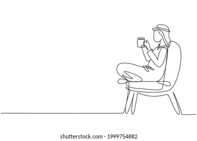 Single continuous line drawing tea time. Relaxed Arabian boy sitting in modern chair, enjoying hot coffee in front of window, side view, free space. One line draw graphic design vector illustration