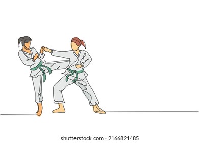 Single continuous line drawing of two young confident karateka girls in kimono practicing karate combat at dojo. Martial art sport training concept. Trendy one line draw design vector illustration