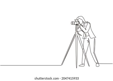 Single continuous line drawing woman paparazzi design concept with photographer shooting appearance of show business stars or other celebrities with tripod. One line draw design vector illustration
