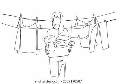 Single continuous line drawing a woman holding a basket filled with piles of clothes. Lift clothes that are dry and clean. Housework. National Hanging Out Day. One line design vector illustration