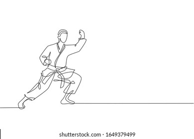 Single continuous line drawing of young confident karateka man in kimono practicing karate combat at dojo. Martial art sport training concept. Trendy one line draw design graphic vector illustration