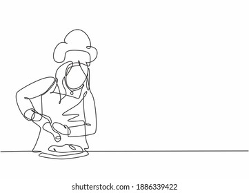 Single continuous line drawing of young happy female chef sparkling salt paper seasoning into meal dish. Preparing organic food for catering concept one line drawing design vector graphic illustration