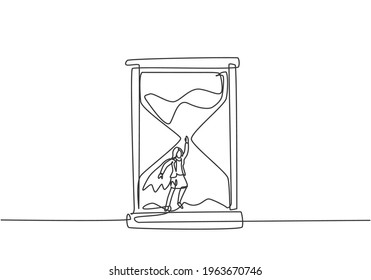 Single continuous line drawing young business woman with wing flying to get out from hourglass. Minimalism metaphor business deadline concept. Dynamic one line draw graphic design vector illustration.