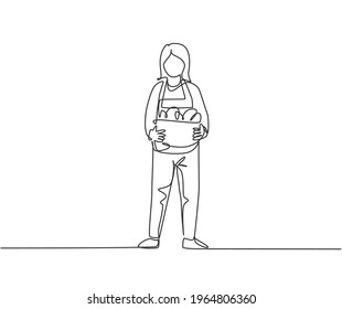 Single continuous line drawing young female farmer standing on farm field and bring basket with full of fruits. Farming minimalism concept. Dynamic one line draw graphic design vector illustration.