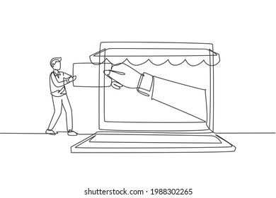 Single continuous line drawing young man inserting credit card into large canopy laptop screen and accepted by hand. Digital payment concept. Dynamic one line draw graphic design vector illustration