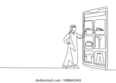 Single continuous line drawing young Arabian man choosing shopping items on a giant smartphone screen. Digital lifestyle with gadgets concept. Dynamic one line draw graphic design vector illustration
