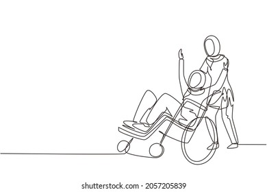 Single continuous line drawing young Arab female volunteer helps disabled old woman, riding on wheelchair in park. Family care, volunteerism, disability care. One line draw design vector illustration