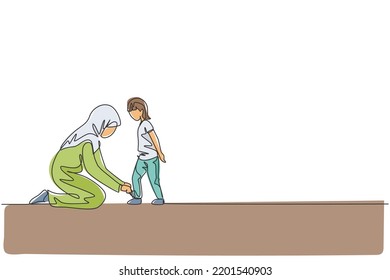 Single continuous line drawing of young Arabian mom help her son to tie shoelace before go to school, happy parenting. Islamic muslim family care concept. One line draw design vector illustration