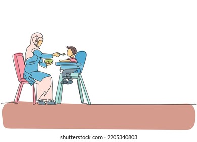 Single continuous line drawing of young Islamic mother feeding organic food to her toddler boy at home. Arabian muslim happy family motherhood concept. Trendy one line draw design vector illustration