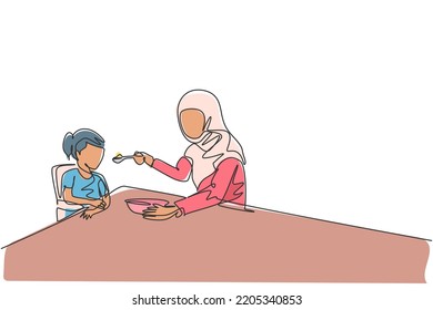 Single continuous line drawing of young Islamic mom feeding healthy food to daughter at breakfast time. Arabian muslim happy family motherhood concept. Trendy one line draw design vector illustration