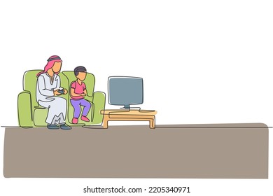 Single continuous line drawing of young Arabian father playing console game at home together with son. Islamic muslim happy family fatherood concept. Trendy one line draw design vector illustration