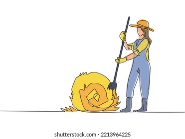 Single continuous line drawing young female farmer was stabbing a haystack and rolling it up with a straw stick. Farming minimalism concept. Dynamic one line draw graphic design vector illustration.