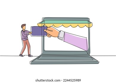 Single continuous line drawing young man inserting credit card into large canopy laptop screen and accepted by hand. Digital payment concept. Dynamic one line draw graphic design vector illustration