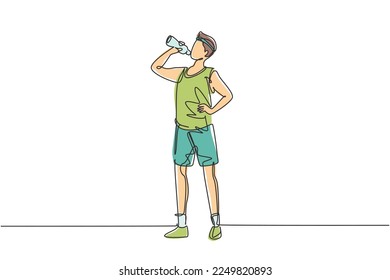 Single continuous line drawing young man standing and drinking fresh water from a bottle with his right hand after exercising. Healthy lifestyles. One line draw graphic design vector illustration