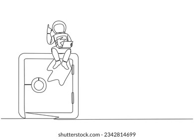 Single continuous line drawing young energetic astronaut sitting on giant safe deposit box holding laptop raise one hand. Store expedition data in a safe place. One line design vector illustration